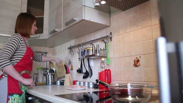 Young Woman Is Cooking In The Kitchen