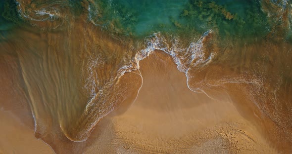 Aerial View of Waves Breaking on the Beach alt