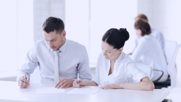 Man And Woman Signing Business Contract At Office 75 alt