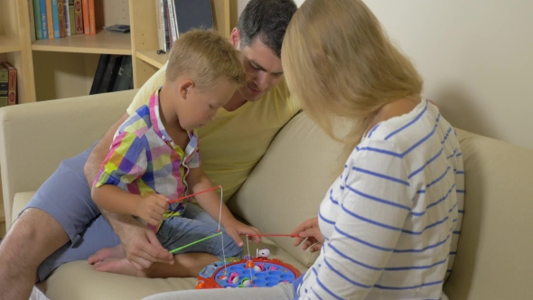 United Family Playing In Toy Fishing Game alt