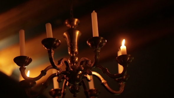 Old Vintage Chandelier With Candles Burning In The Dark