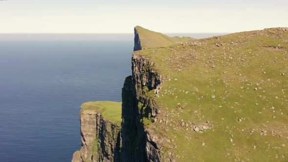 Drone Shot Of Men Hiking By Mylingur Mountain On Streymoy Island alt