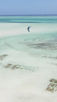 Vertical Video Kitesurfing Near the Shore of Zanzibar Tanzania alt