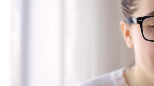 Happy Woman In Eyeglasses With Smartphone At Home