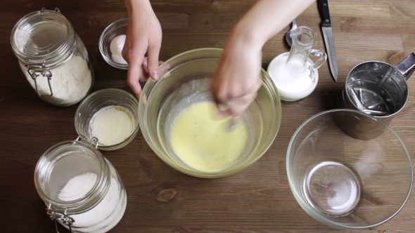 Cooking Muffins: Adding And Mixing Flour, Milk , Oil, Sugar. 