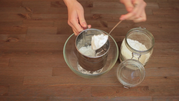 Woman Preparing On The Kitchen, Sifting Flour.