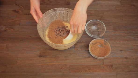 Woman Preparing a Muffins On The Kitchen Mixes Ingredients