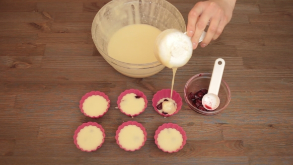 Woman Preparing a Muffins On The Kitchen