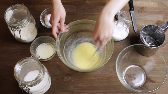   Cooking Muffins: Adding And Mixing Flour, Milk , Oil, Sugar. 