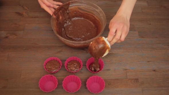 Woman Preparing a Muffins On The Kitchen