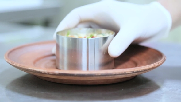 Cook Picks Up a Form For Salad