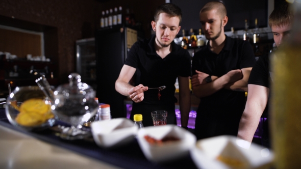 Several Bartenders In Stylish Black Shirts, Work In Intensive Mode alt