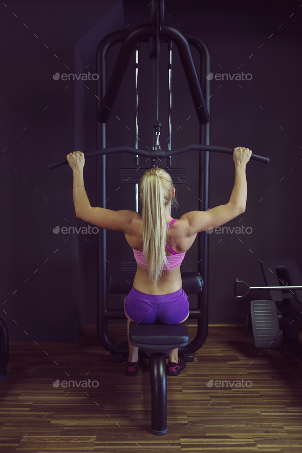 Strong and beautiful athletic woman training in the gym Stock Photo by arthurhidden