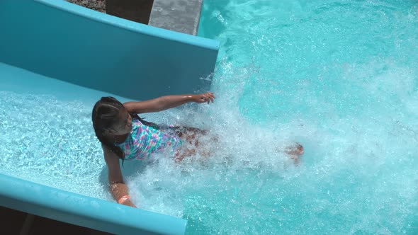 Girl going down waterslide in super slow motion