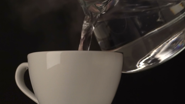 Hot Water Pouring  From Glass Teapot