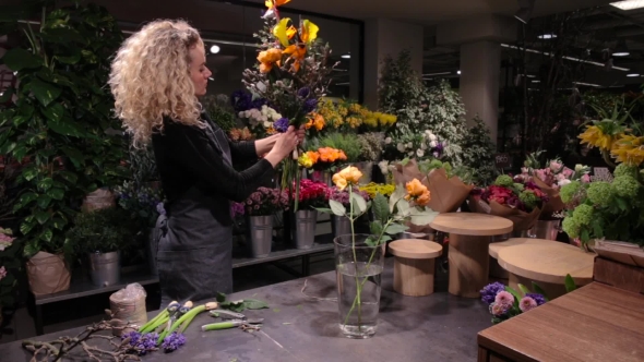 Beautiful Woman Florist Making a Bouquet At Flower Shop
