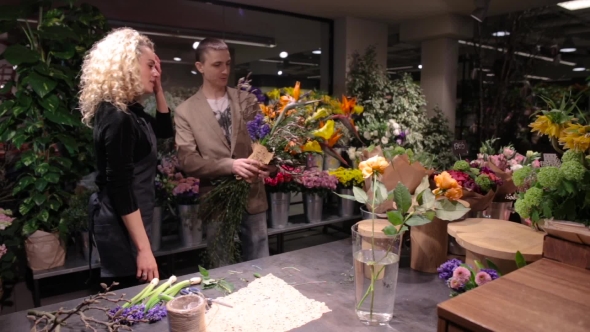 Young Man Buys a Bouquet At Flower Shop