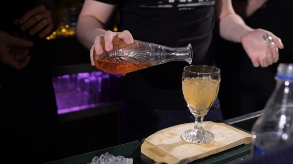 Bartender Is Making Cocktail. Complex Preparation Of Various Ingredients alt