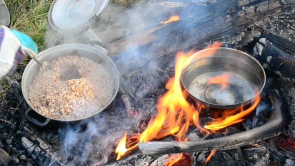 Cooking Buckwheat Porridge And Warming Water On Open Fire