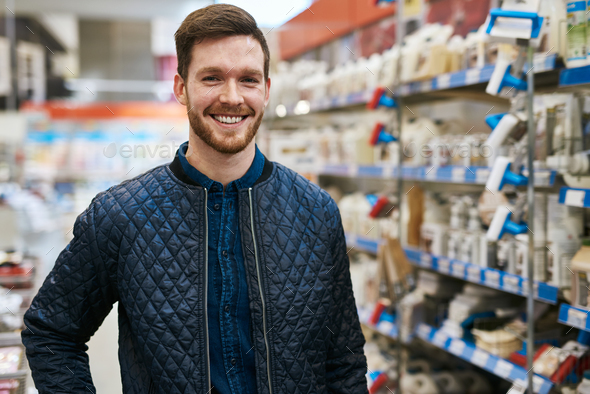 Friendly handsome man in a hardware store - Stock Photo - Images