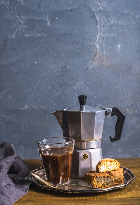 Glass espresso coffee on rustic wooden board, cantucci biscuits and steel  Italian Moka pot Stock Photo by sonyakamoz