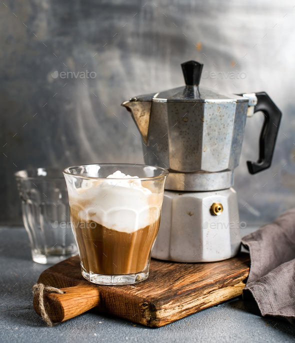 Glass espresso coffee on rustic wooden board, cantucci biscuits