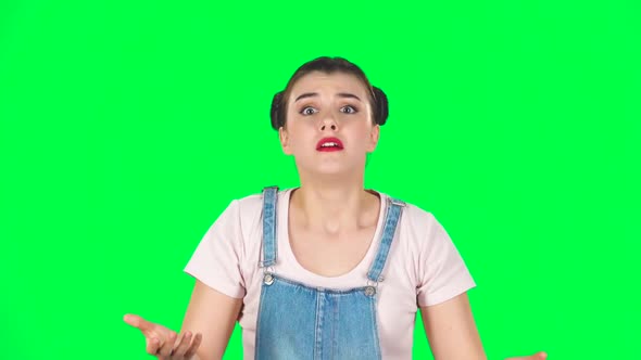Girl Looking at Camera with Anticipation, Then Very Upset Against Green Screen. Slow Motion alt