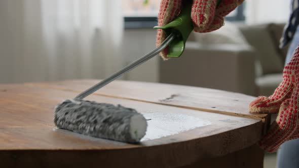 Hands Painting Old Wooden Table with Grey Color alt