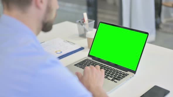 Creative Man Video Call on Laptop with Chroma Screen alt