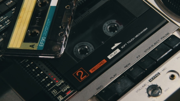 Pushing a Finger Play And Stop Button On a Two Decks Tape Recorder alt