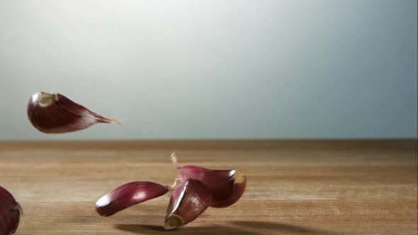 Garlic clove pieces bouncing in ultra slow motion 1500fps on a wooden surface - BBQ PHANTOM  alt