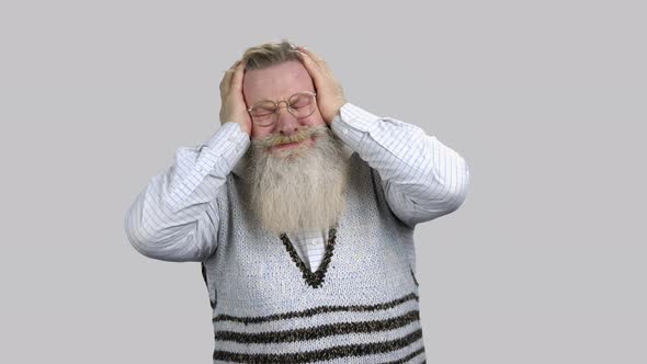 Elder Man with Terrible Head Pain Touching Head with Both Hands alt