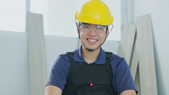 Portrait of Asian Craftsman or Carpenter labor worker male wear work safety helmet and eyeglass, smi alt