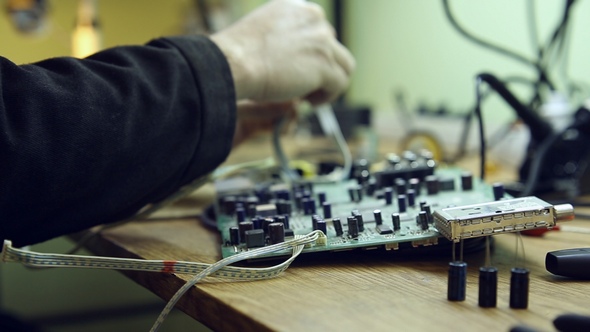 Scientist in Laboratory Parses the Device  alt