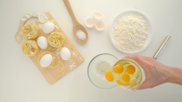 Flour And Eggs On a White Wooden Board
