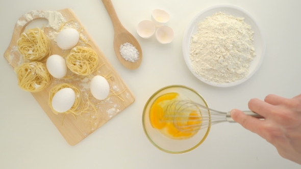 Cooking With Eggs, Raw Eggs In a Dish And Flour On a Table.
