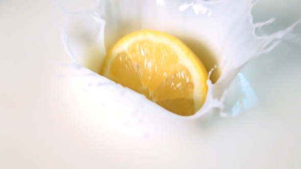 Half Of Lemon Drops Into The Milk alt
