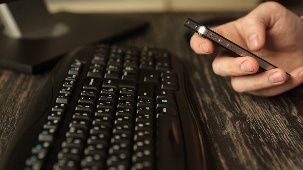 Mobile Phone At Wooden Desk alt