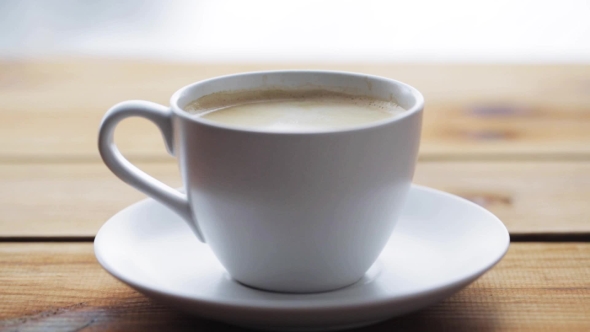 Sugar Falling Into Cup Of Coffee On Wooden Table 68 alt