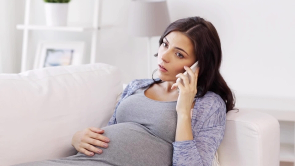 Sad Pregnant Woman Calling On Smartphone At Home 25 alt