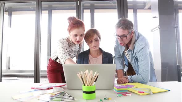 Female Creative Executive Discussing A New Project On Laptop With Team 2 alt