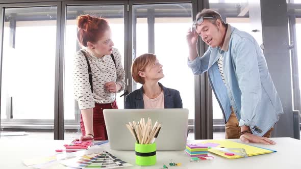 Female Creative Executive Showing To Director And Colleague Project On Laptop 1 alt