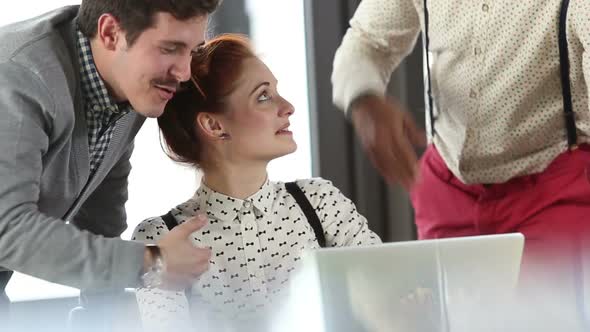 Young Creative Team Discussing Plans And High-Fiving alt