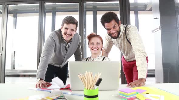 Young Creative Team Smiling And Looking At Camera alt