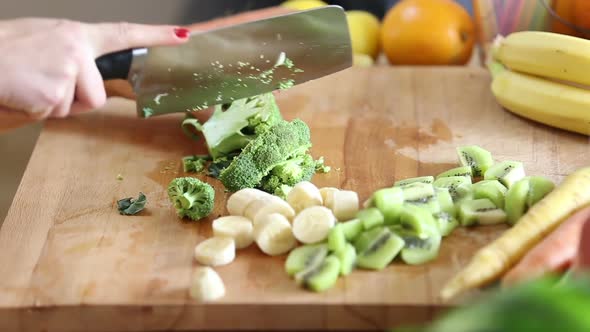 Close-Up Of Cutting Broccoli With Knife 1 alt