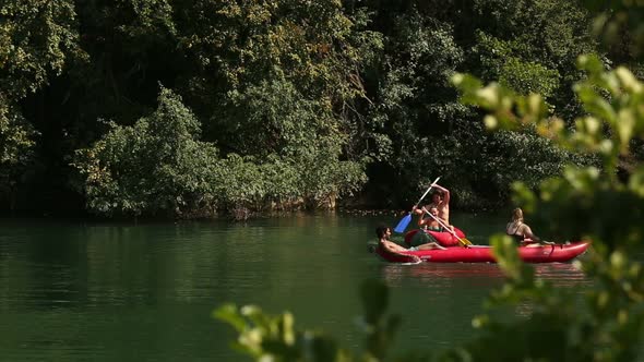 Friends Enjoying Paddling In Canoe On River 2 alt