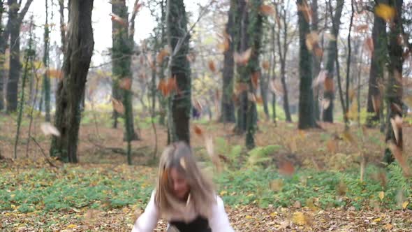 Girl Having Fun Throwing Leaves And Jumping In The Park By Paulprescott