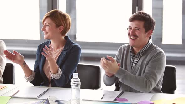 Colleagues Smiling And Applauding After Presentation 1 alt