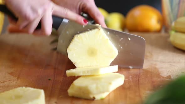 View Of Woman Hands Cutting Pineapple Into Slices alt