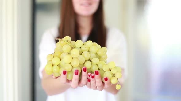View Of Woman Hands Holding Bunch Of Grapes 1 alt
